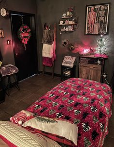 a bedroom decorated for christmas with pink lights and decorations on the wall above the bed