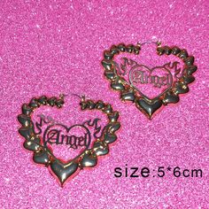 two heart shaped earrings with the word family on them