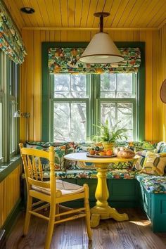 a kitchen with yellow walls and green trim on the window sill, wooden flooring