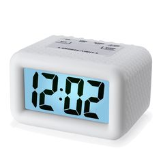 the alarm clock is white and has two blue numbers on each side, as well as an hour