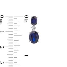 A timeless addition to her wardrobe, these fashion drop earrings are a style must-have. Crafted in sterling silver, each earring showcases an 8.0 x 6.0mm oval-shaped lab-created bright blue sapphire dangle suspended from a shimmering lab-created white sapphire. A 6.0 x 4.0mm oval-shaped created blue sapphire post completes this charming design. Buffed to a brilliant luster, these earrings secure comfortably with friction backs. Timeless Oval Gemstone Earrings, Elegant Oval Pendant Earrings For Anniversary, Timeless Oval Sterling Silver Earrings, Formal Oval Pendant Gemstone Earrings, Elegant Oval Sterling Silver Earrings, Timeless Oval Hallmarked Earrings, Formal Oval Sterling Silver Earrings, Elegant Sterling Silver Oval Pendant Earrings, Peoples Jewellers