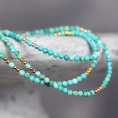 This handmade, genuine Turquoise Bracelet for women is dainty yet striking, bringing a colourful, boho touch to any outfit. Stylish and minimal worn alone, but great to mix, match & stack. A very dainty, skinny bracelet with a delicate, feminine, minimal look - made with 2.25mm tiny turquoise beads. Featuring genuine, natural, un-dyed Turquoise in a variety of green, turquoise and teal shades - all the beautiful shades of the tropical seas! Excellent cut with many facets, showing off the gor Turquoise Wrap Bracelet With Round Beads As Gift, Turquoise Bracelets With Tiny Beads As Gift, Turquoise Bracelets With Tiny Beads For Gifts, Bohemian Turquoise Friendship Bracelets With Spacer Beads, Turquoise Wrap Bracelet With Faceted Beads As Gift, Turquoise Beaded Bracelets With Faceted Beads For Festival, Turquoise Gemstone Beaded Bracelets For Festivals, Festival Turquoise Beaded Bracelets With Faceted Beads, Spiritual Turquoise Beaded Bracelets With Tiny Beads