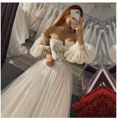 a woman taking a selfie while wearing a wedding dress