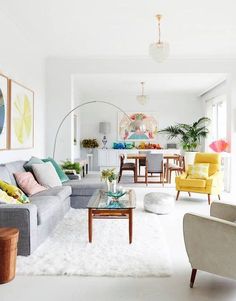 a living room filled with furniture and lots of white furnishing on the floor