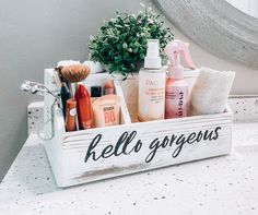 a white wooden box filled with personal care items on top of a bathroom counter next to a mirror