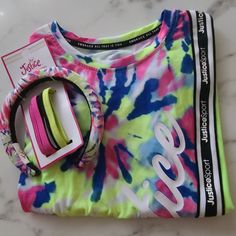 This Justice Sport Collection Is For The Girl On The Go. Rugged Yet Playful. Mix And Match Using Biker Shorts, Shorts, Leggings, Etc. The Tee Also Comes With Matching Hair Accessories To Complete The Look. Tie Dye Collection Tie Front Justice Sport Band Along The Front Side Along With The Word "Justice" In White Glitter Lettering Lime Green, Pink, Lt Blue Girls Size: Small =7/8 Girls Size: Medium = (10) Recycled Polyester So It's Great For Mother Earth. Machine Washable (Inside Out) Hang Of Tumb Multicolor Spring T-shirt For Playwear, Cute Summer Sets With Crew Neck, Multicolor Spring T-shirt For Play, Multicolor Summer Sets With Crew Neck, Multicolor Crew Neck Sets For Summer, Multicolor Spring Crew Neck Set, Trendy Pink Crew Neck Set, Pink T-shirt For Playwear In Summer, Pink T-shirt For Playwear And Summer