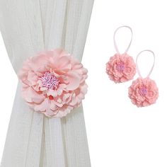 the pink flower is attached to the curtain with two matching hair clips and one pair of headbands