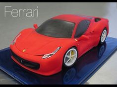 a red toy car sitting on top of a blue plate with the word ferrari written across it