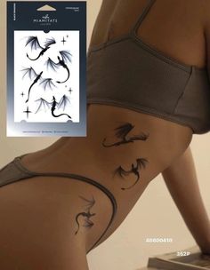 a woman's stomach with tattoos on it and an image of a dragon in the background