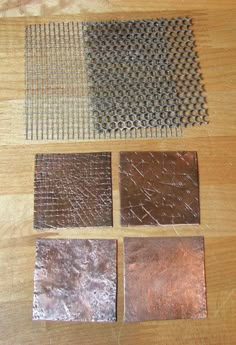 four different types of tile laid out on a wooden table with metal grates in the middle