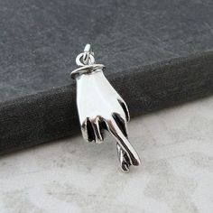 "This Crossed Fingers Charm comes with a silver jump-ring as pictured. Please note that photo is not to scale and may appear larger to show detail. Refer to exact measurements below. Additional attachments (lobster clasp, large-hole bead, necklace chains) are available from the charm-attachments drop-down menu.  For a visual example of the different attachments and what each one is best suited for, scroll through the photos until you see the example photo or visit https://etsy.me/2BY7DAW for detailed information.    { DETAILS } ★ Material: Sterling Silver ★ Finish Color: Silver  ★ Measurements: 3/8\" x 3/4\" ★ Dimensions: 3-Dimensional ★ Made in the USA { SIMILAR ITEMS }  More good luck themed items available from my shop: https://www.etsy.com/shop/treasuredcharms/search?search_query=luck Pandora Beads, Fingers Crossed, Luck Charm, Large Hole Beads, Crossed Fingers, Luck Charms, Cross Charms, Pandora Bracelet, Charm Gift