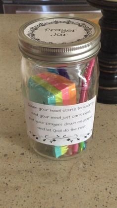 a jar filled with lots of different colored blocks