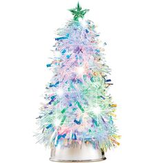 a brightly lit christmas tree in a silver tin with stars on the top and bottom