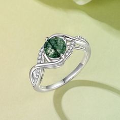 This sterling silver ring features a round green moss agate stone as the main stone that radiates a mysterious and enchanting glow. Symbolizing calm and vitality, the green moss agate's unique colors and textures seem like a painting of nature, while the infinity symbol's design symbolizes endless emotion and commitment. Whether worn as everyday jewelry or as a gift for a special occasion, this moss agate ring will add a unique charm to your appearance.Weight: 3.6 gMaterial: 925 SilverPlating Color: Silver Green Sterling Silver Crystal Ring, Elegant Green Moss Agate Rings, Elegant Silver Moss Agate Rings, Green Round Crystal Promise Ring, Green Crystal Round Promise Ring, Green Moss Agate Gemstone Ring, Green Moss Agate Ring Jewelry, Infinity Symbol Design, Moss Agate Ring