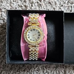 Brand New Gold And Crystal Embellished Watch With Roman Numerals. Makes A Beautiful Gift! Comes In A Gift Box Party Watch With Rhinestones And Round Dial, Bling Metal Diamond Watch As Gift, Gift Metal Diamond Watch With Bling, Gift Diamond Bling Watch, Party Diamond Watch With Rhinestones, Rhinestone Watches Perfect As Gifts, Rhinestone Watches With Round Dial, Party Watches With Rhinestones, Gold Party Watches With Rhinestones