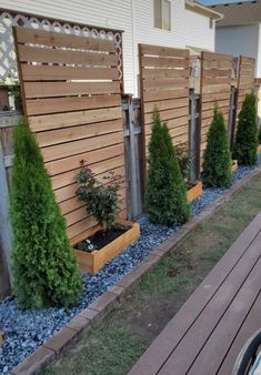 a row of wooden planters in front of a house