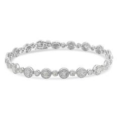 Round cut, miracle set diamonds twinkle in this simple and sleek bracelet. Each diamond is set at the center of a beaded circle that when linked together give life to the bracelet design. 1 1/3ct TDW of promo quality diamonds sparkle in this sterling silver jewelry piece. Promo quality diamonds are on the lowest of diamond color and quality scale. Round-cut, promo quality diamonds are milky and cloudy in nature. They have asymmetrical ball shape and are filled with inclusions. Bracelet Stands, Bracelets Design, Jewelry Essentials, Round Design, Pendant Bracelet, Sterling Silver Bracelet, Quality Diamonds, Free Jewelry, Bracelet Designs