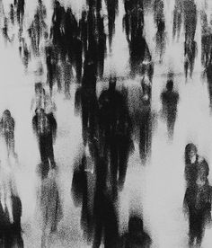 black and white image of people walking down the street