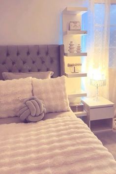 a bedroom with a bed, nightstand and window