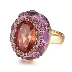 a ring with an oval shaped red and purple stone surrounded by smaller round pink stones