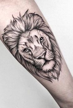 a black and white lion tattoo on the arm