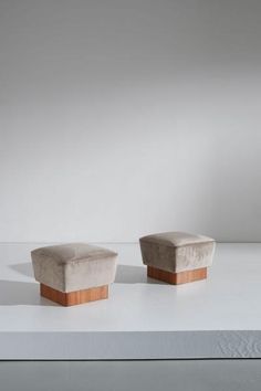 two small stools sitting on top of a white countertop next to each other