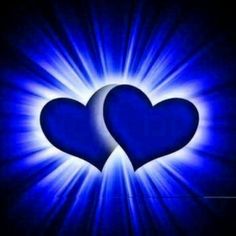 two blue hearts in the middle of a black background with bright light coming from behind them