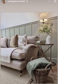 a living room with a couch, chair and coffee table in front of a wall