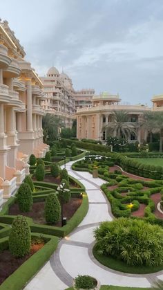 an elaborate garden in the middle of a large building with many windows and balconies