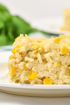 a white plate topped with rice and corn