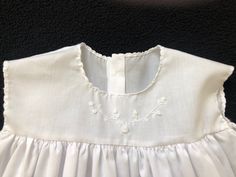 "This slip is perfect for a long Christening gown, Dedication gown, Baptismal gown or any length gown. This particular gown is 30 1/2\" long and made from white Imperial batiste. There is embroidery done by hand on the front bodice. It is an empire style slip which has Swiss cotton lace at the hemline. It closes with two small buttons on the back. This gown can be custom made to whatever length is needed and can be made with satin batiste, cotton broadcloth, Imperial batiste or the fabric of you Classic Fitted Baptism Gown, Classic Fitted Gown For Baptism, Fitted Gown For Baptism In Spring, Fitted Gown For Spring Baptism, Classic Summer First Communion Dress, Elegant Spring Baptism Gown, Classic Baptism Gown With Lace Trim, Classic Baptism Dress For Summer Daywear, Spring Baptism Gown With Ruffles