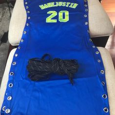 the back of a chair that has a basketball jersey on it and a pair of black laces