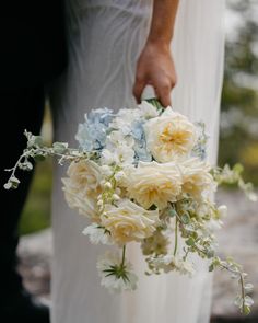 a close up of a person holding a bouquet of flowers