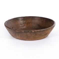 a wooden bowl sitting on top of a white table