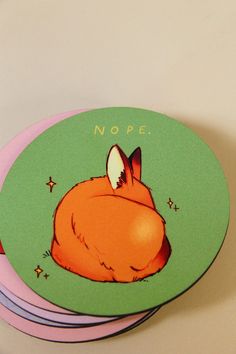 four coasters with an image of a sleeping fox on one side and the words nope on the other