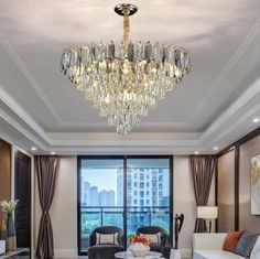 a living room filled with furniture and a chandelier hanging over the top of it