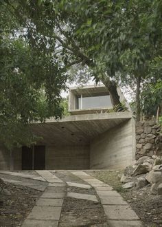 an outdoor area with stone steps leading up to a building that is made out of concrete