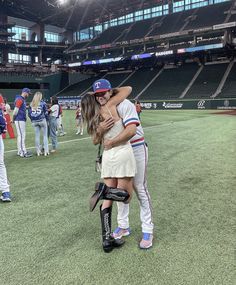 two baseball players hug each other on the field