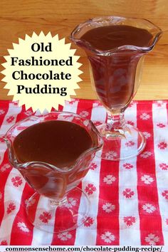 two glasses filled with chocolate pudding sitting on top of a red and white table cloth