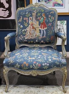 an ornate chair with blue upholstered fabric