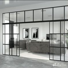 an open living room with glass doors leading to the outside