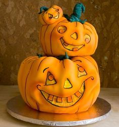 three carved pumpkins sitting on top of each other