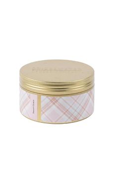 a small tin with a pink and white plaid pattern on it, in front of a white background