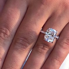 a woman's hand with a ring on it and a diamond in the middle