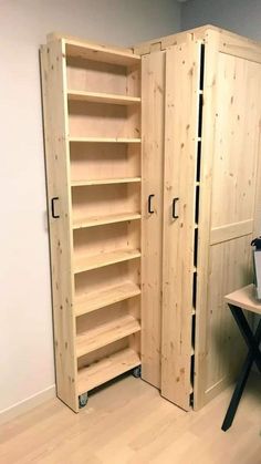 an empty room with wooden shelves and a computer desk