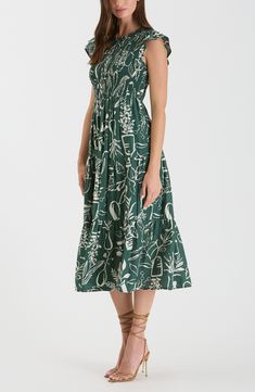 A linear print boosts the whimsical appeal of a midi-length dress shaped by a smocked bodice and delicate fluttering sleeves. 50" length (size Small) Back keyhole with button closure 80% rayon, 20% nylon Hand wash, line dry Imported Beach Midi Dress With Gathered Neckline, Midi Dress With Gathered Neckline For Beach, Vacation Midi Dress With Gathered Neckline, Midi Dress With Gathered Neckline For Vacation, Green Tiered Midi Dress With Smocked Bodice, Flowy Smocked Midi Dress With Gathered Neckline, Casual Midi Dress With Gathered Neckline For Garden Party, Midi Dress With Smock Detail For Garden Party, Green Summer Midi Dress With Gathered Neckline