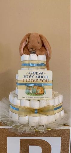 a diaper cake with a stuffed rabbit on top