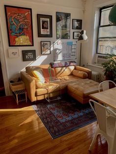 a living room filled with furniture and lots of pictures on the wall above it's windows