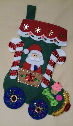 a christmas stocking made out of felt with santa clause on it and other decorations