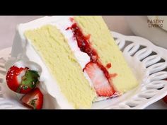 a slice of cake with strawberries on the side sitting on a white platter